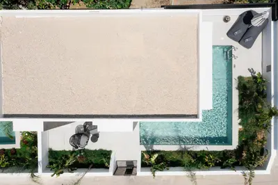 an overhead view of a swimming pool and a beach at Three Doors Villa Complex in Faliraki