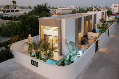 a house with a swimming pool and plants on it at Three Doors Villa Complex in Faliraki