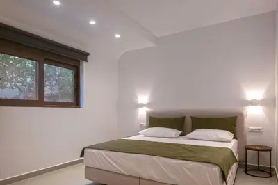a bedroom with a bed with two pillows and a window at Ortus Luxury Residence in Rhodes Town