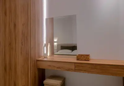 a mirror on a wooden shelf in a room at Ortus Luxury Residence in Rhodes Town