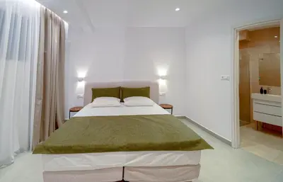 a bedroom with a large bed in a room at Ortus Luxury Residence in Rhodes Town