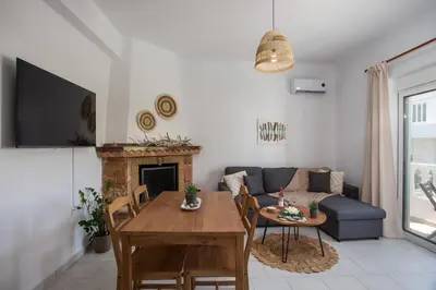 a living room with a couch and a table at Niriana Verde Apartment in Gennadi