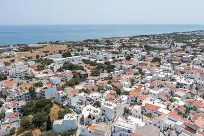 an aerial view of a city with white buildings at Niriana Verde Apartment in Gennadi