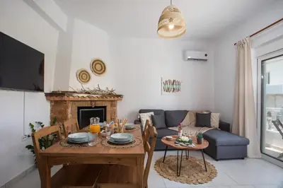 a living room with a table and a couch at Niriana Verde Apartment in Gennadi