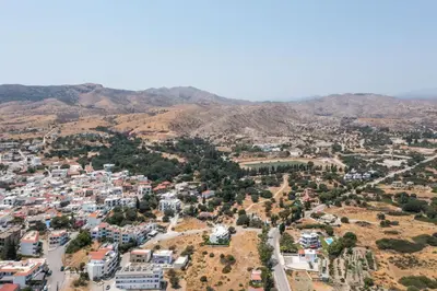 an aerial view of a city with mountains in the background at Niriana Verde Apartment in Gennadi