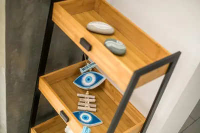 a wooden table with some knick knacks on it at Niriana Verde Apartment in Gennadi