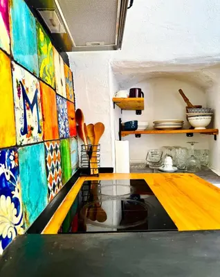 a kitchen with colorful tiles on the wall at Villa Kastrouna, with private heated jacuzzi in Symi