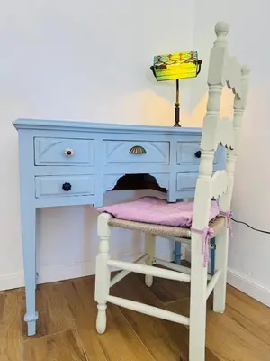 a blue dresser with a chair and a desk at Villa Kastrouna, with private heated jacuzzi in Symi