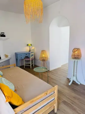 a bedroom with a large bed and two lamps at Villa Kastrouna, with private heated jacuzzi in Symi