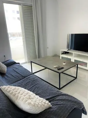 a bedroom with a table and a bed and a tv at Diagoras Suites in Rhodes Town