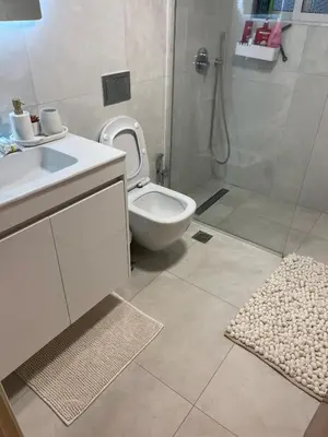 a bathroom with a toilet and a sink and a shower at Diagoras Suites in Rhodes Town