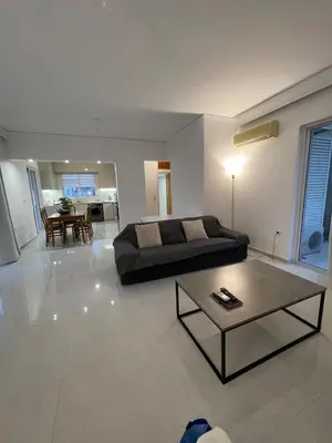 a living room with a couch and a coffee table at Diagoras Suites in Rhodes Town