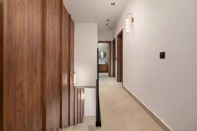 a hallway of a house with white walls and wood at Lanik Luxury Pool Villa in Afantou