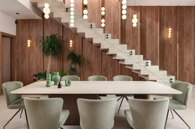 a dining room with a table and a staircase at Lanik Luxury Pool Villa in Afantou