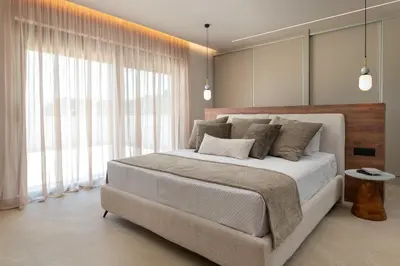 a bedroom with a large bed and large windows at Lanik Luxury Pool Villa in Afantou