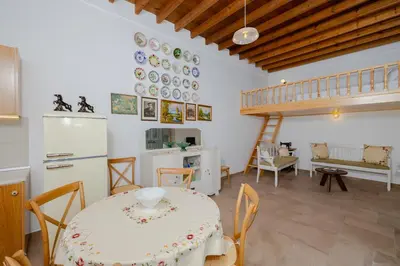 a kitchen and dining room with a table and chairs at Ikia Damianou Traditional House in Archangelos