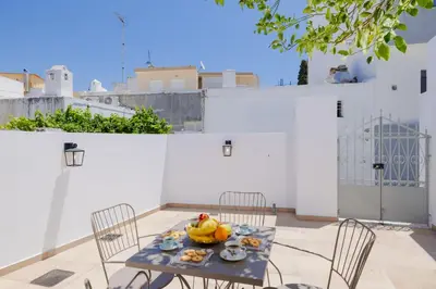 a table and chairs with a bowl of fruit on it at Ikia Damianou Traditional House in Archangelos