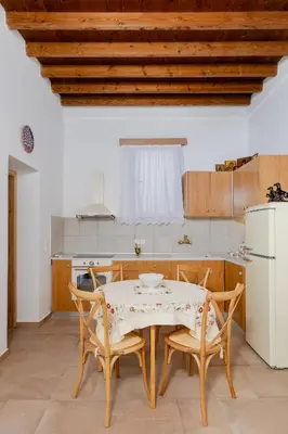 a kitchen with a table and chairs in a kitchen at Ikia Damianou Traditional House in Archangelos