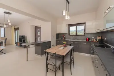 a large kitchen with a wooden table and chairs at Casa Del Silencio in Pastida