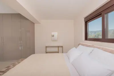 a white bedroom with a bed and a window at Casa Del Silencio in Pastida