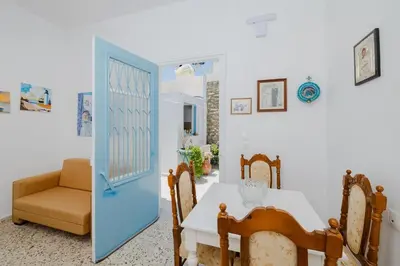 a dining room with a table and a chair at Statis House in Lardos