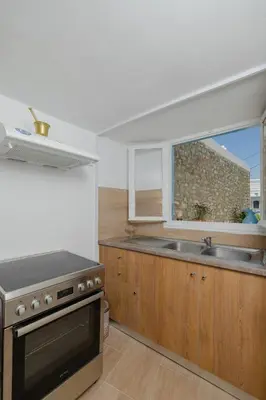a kitchen with a stove and a sink and a window at Statis House in Lardos
