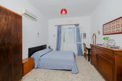 a bedroom with a bed and a dresser and a desk at Statis House in Lardos