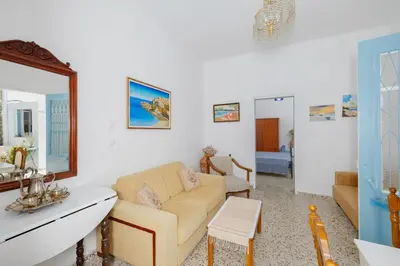 a living room with a couch and a mirror at Statis House in Lardos