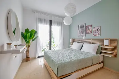 a bedroom with a bed and a large window at Anna Maria Suite in Rhodes Town