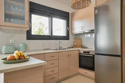 a kitchen with a bowl of fruit on a counter at Anna Maria Suite in Rhodes Town