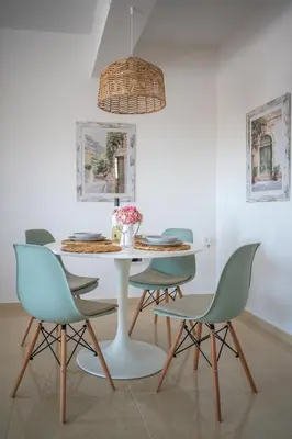 a dining room with a white table and chairs at Anna Maria Suite in Rhodes Town