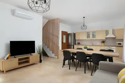a kitchen and dining room with a table and chairs at Le Soleil De Lindos - Luxury Villa with Swim Spa in Líndos