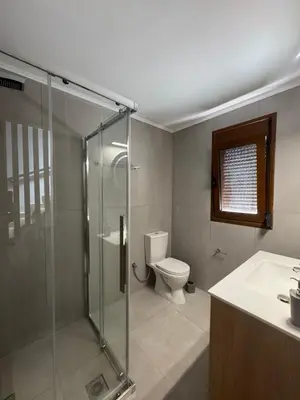 a bathroom with a toilet and a glass shower at Le Soleil De Lindos - Luxury Villa with Swim Spa in Líndos