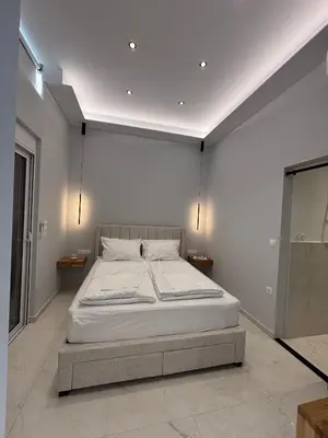 a bedroom with a large bed in a room at Kyra Maria 3, Loft in Rhodes Town