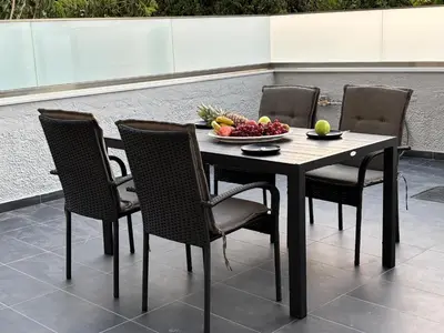 a table and chairs with a bowl of fruit on it at Kyra Maria 3, Loft in Rhodes Town