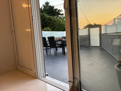 a sliding glass door leading to a patio with a table at Kyra Maria 3, Loft in Rhodes Town