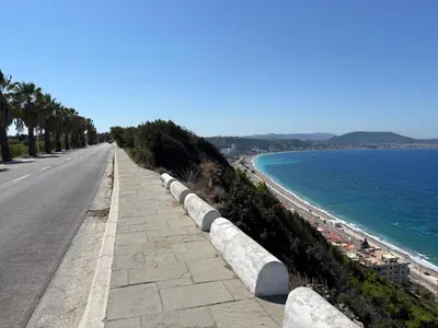 a road next to a beach with the ocean at Kyra Maria 3, Loft in Rhodes Town