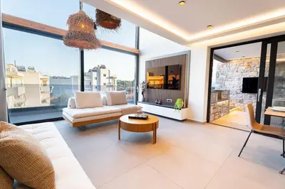 a living room with a couch and a table at Etheras 2 - Holiday Apartments in Asgourou