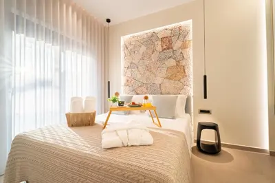 a bedroom with a bed with a table on it at Etheras 2 - Holiday Apartments in Asgourou