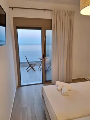 a bedroom with a bed and a large window at VILLA PAVA MARE sea view brand new 2025 in Vrachonisída touArchangélou