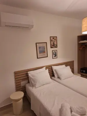 two beds in a room with white walls at VILLA PAVA MARE sea view brand new 2025 in Vrachonisída touArchangélou