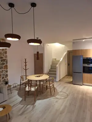 a kitchen and dining room with a table and chairs at VILLA PAVA MARE sea view brand new 2025 in Vrachonisída touArchangélou