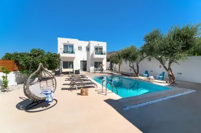 a swimming pool in front of a villa at Gioiello Villa in Pefki Rhodes