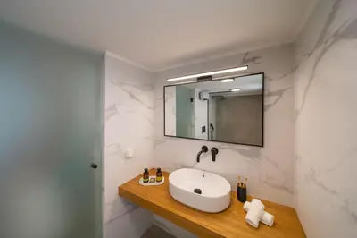 a bathroom with a sink and a mirror at Gioiello Villa in Pefki Rhodes
