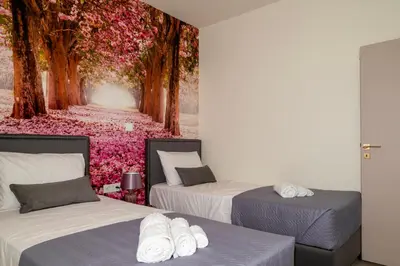 a room with two beds and a wall with flowers at Paradissia Luxe Villa with Private Swimming Pool in Paradeísion