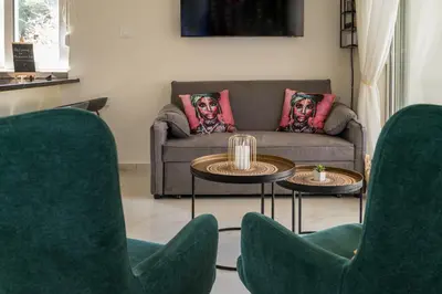 a living room with a couch and two tables and chairs at Paradissia Luxe Villa with Private Swimming Pool in Paradeísion