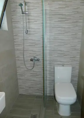 a bathroom with a toilet and a shower at Roseberry Studios in Faliraki