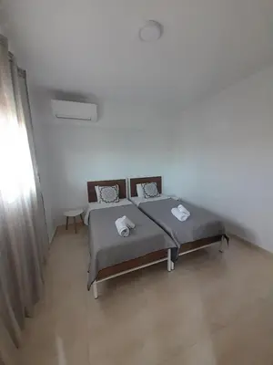a bedroom with a bed in a white room at Roseberry Studios in Faliraki