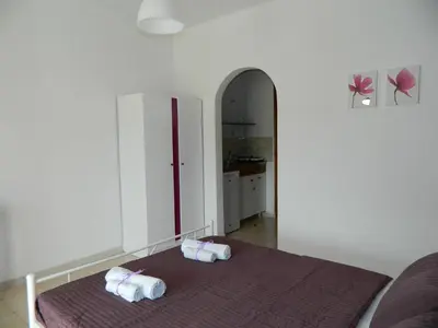 a room with a bed with two towels on it at Roseberry Studios in Faliraki