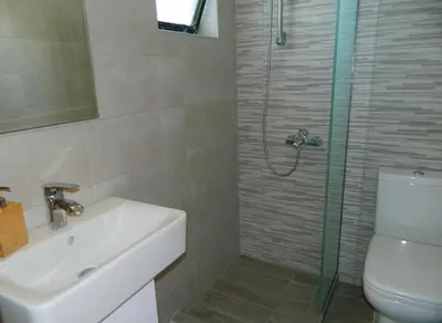 a bathroom with a toilet and a sink and a shower at Roseberry Studios in Faliraki